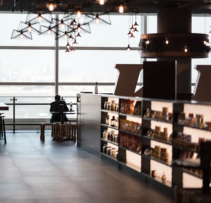Airport concession with dining area next to floor to ceiling windows